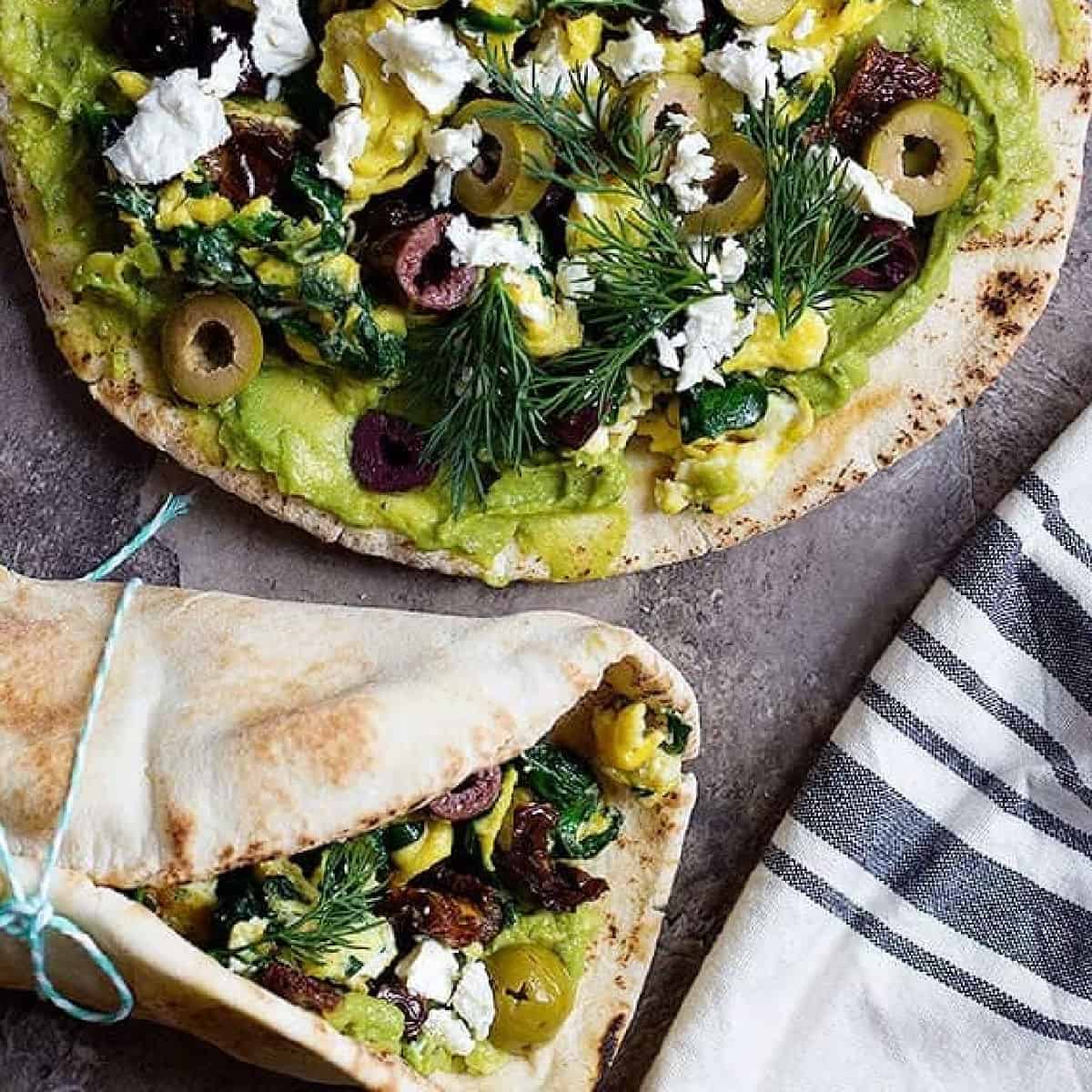 Avocado Egg Sandwich with a Greek twist is ready in 20 minutes and is perfect for breakfast. Avocado and egg wrapped in pita with some olives and feta offers so much flavor in every bite.
