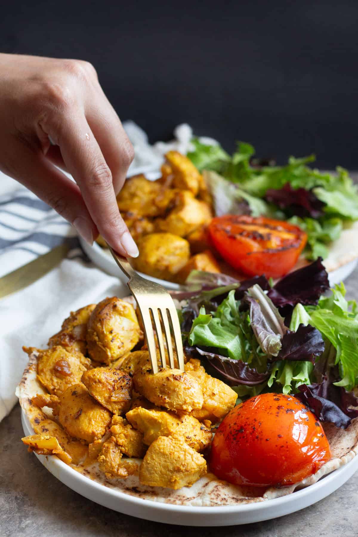 fork inserted into grilled saffron chicken kabobs. 
