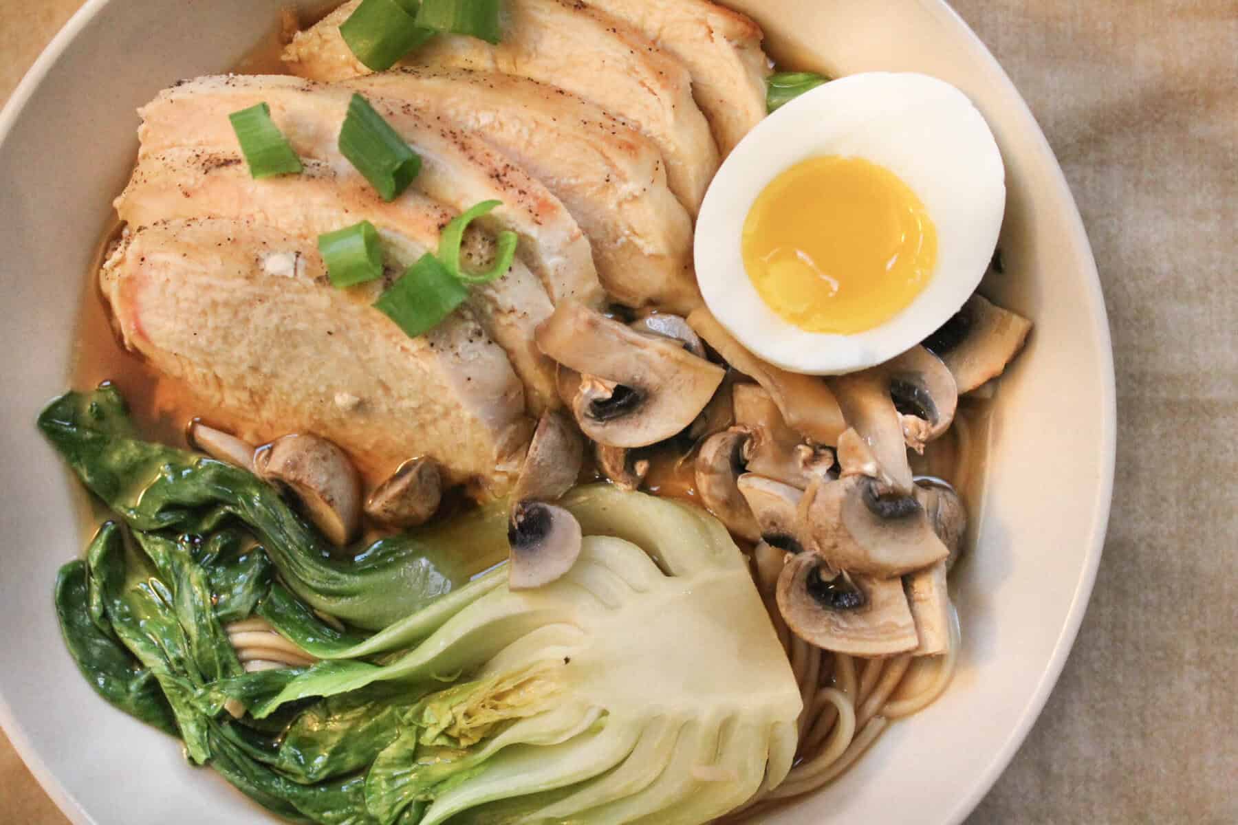 Chicken ramen is perfect for weeknight dinners. Top with eggs, chicken and bok choy.