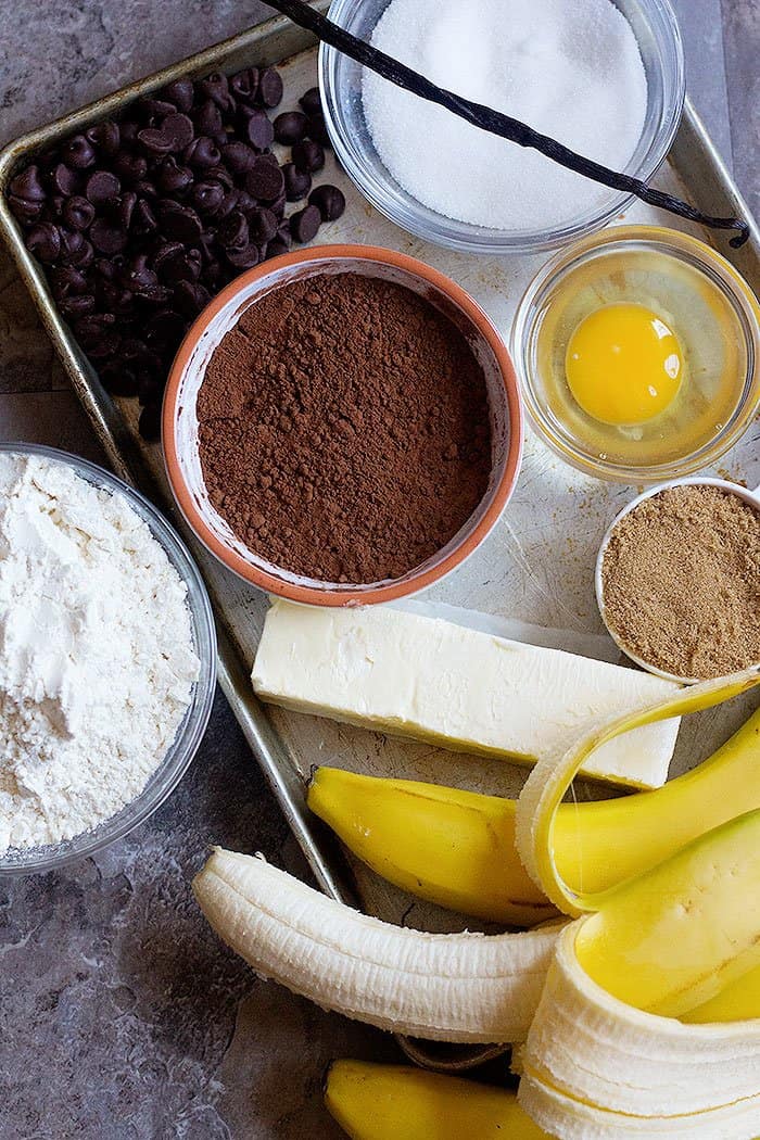 cocoa banana bread ingredients are bananas, sugar, egg, chocolate chips, cocoa powder, flour and butter.