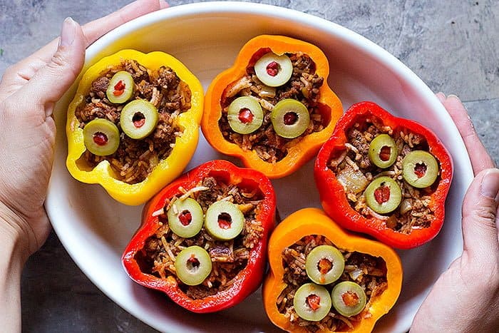 To make greek stuffed peppers, fill the bell peppers with the filling and bake in the oven. 
