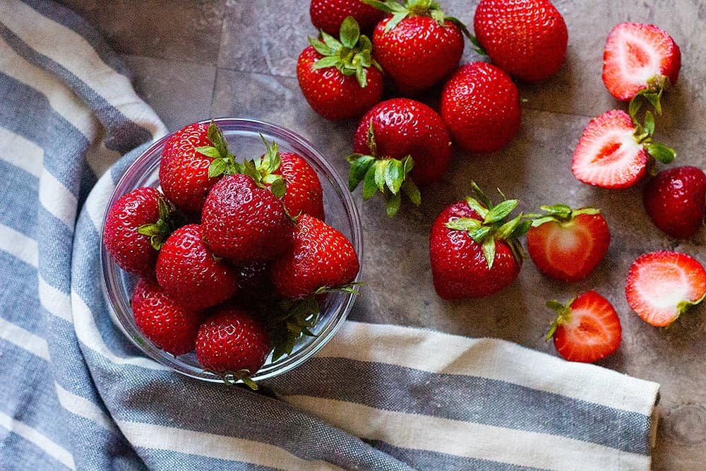 a large bowl of fresh strawberries for strawberry cobbler recipe. 
