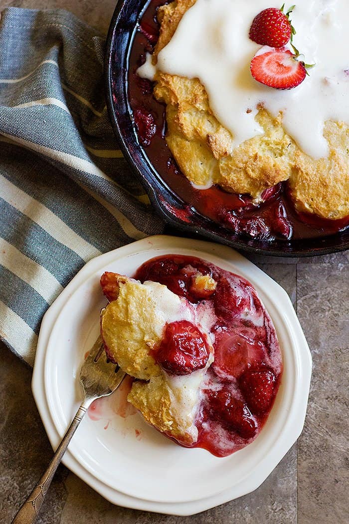 This strawberry cobbler recipe is easy to follow and has a thick filling and is topped with vanilla ice cream. 