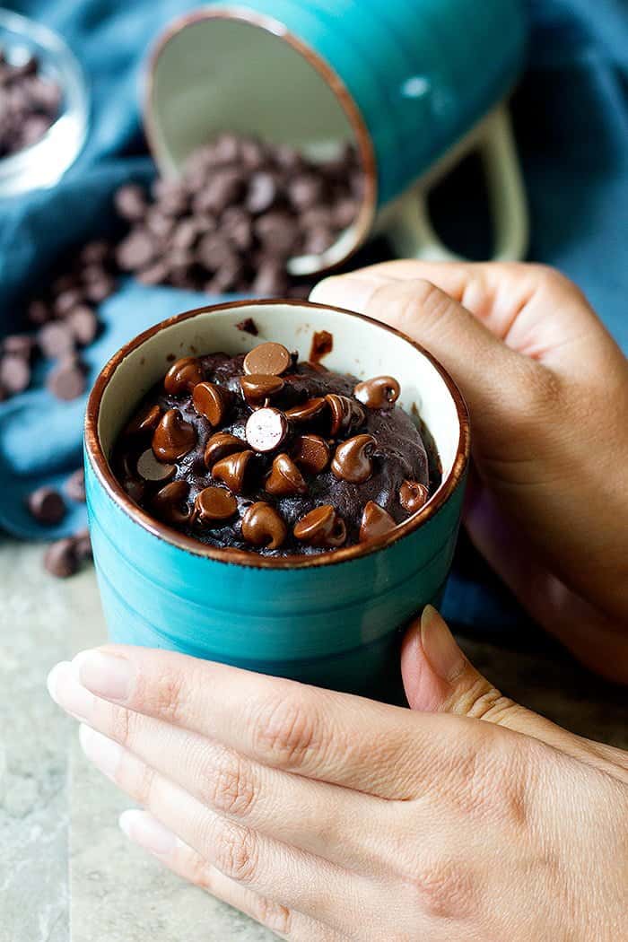 Brownie in a mug with chocolate chips on top.