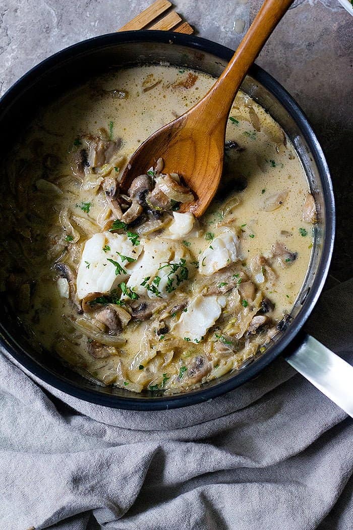 place the seared cod back in the pan to absorb flavor. 