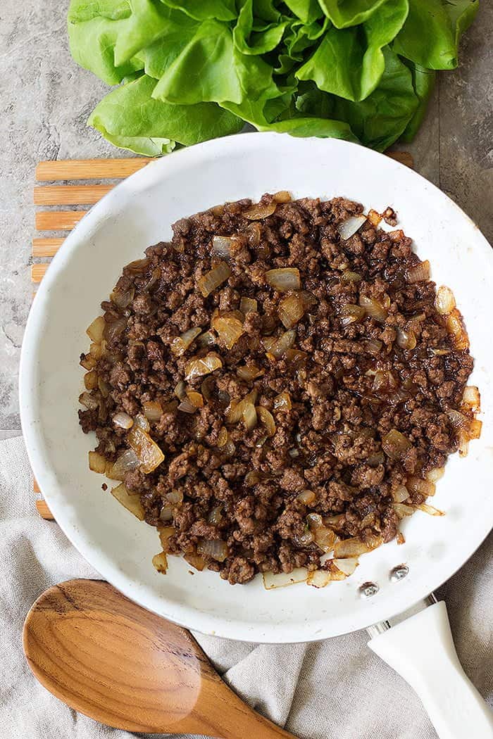 To make Korean ground beef recipe, saute onion and ground beef with garlic and then add soy sauce and sugar. 