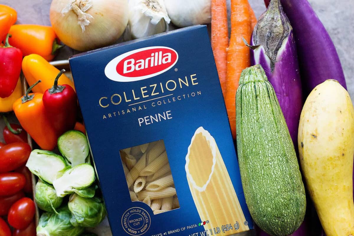 To make pasta with roasted vegetables you need pasta, peppers, zucchini, eggplant, onion, garlic, tomato and brussels sprouts. 