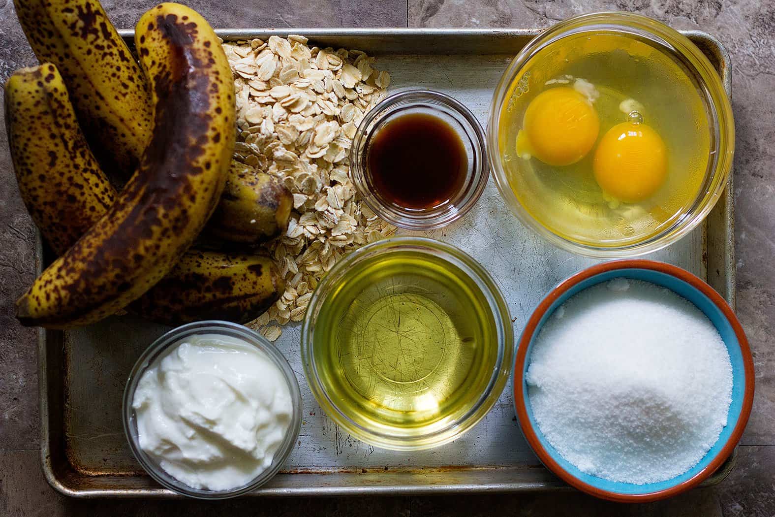For oatmeal banana bread recipe, you need bananas, oatmeal, flour, yogurt, eggs, vanilla, vegetable oil. 