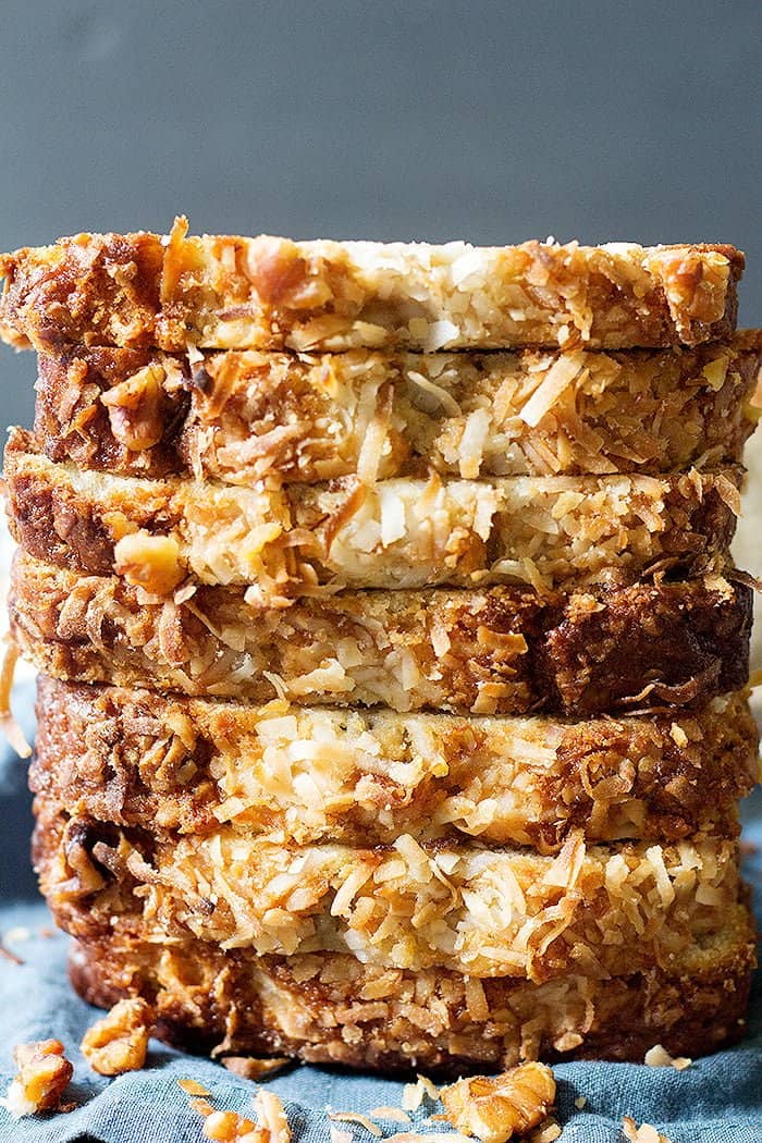 Slices of coconut banana bread stacked on top of each other. 