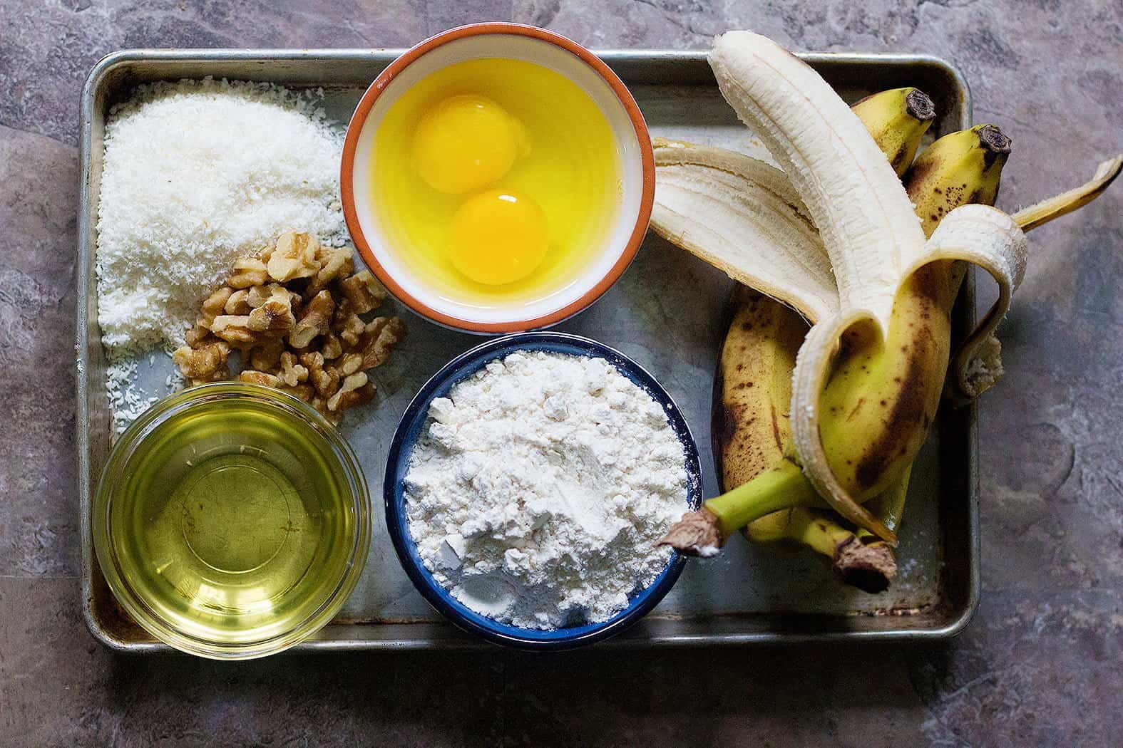 To make banana coconut bread you need bananas, eggs, coconut, flour, walnuts and vegetable oil. 