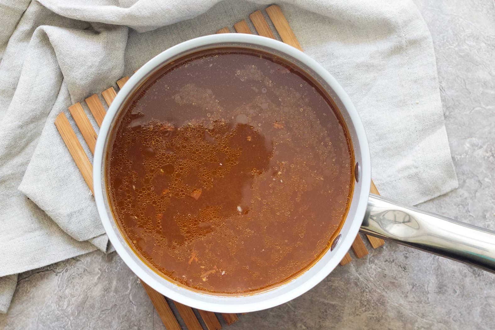 To make Spicy ramen soup base mix chicken stock, soy sauce, spices, sriracha, soy sauce and water to boil and simmer for 25 minutes. 