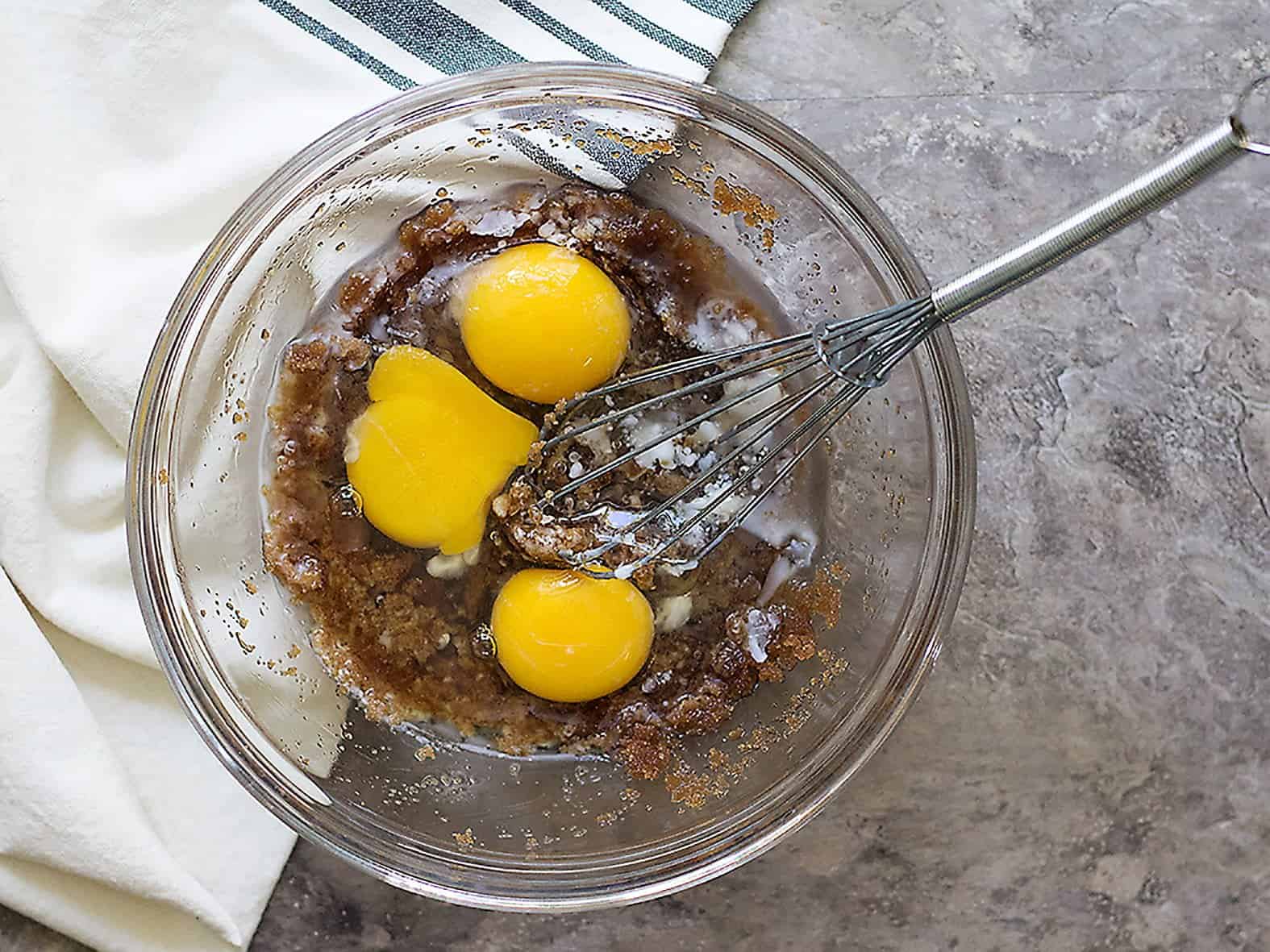 In a large bowl, mix coconut oil, eggs and brown sugar. 