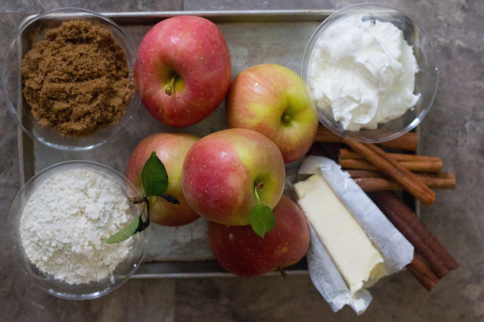 homemade apple cobbler ingredients are apples, brown sugar, yogurt, butter and flour. 