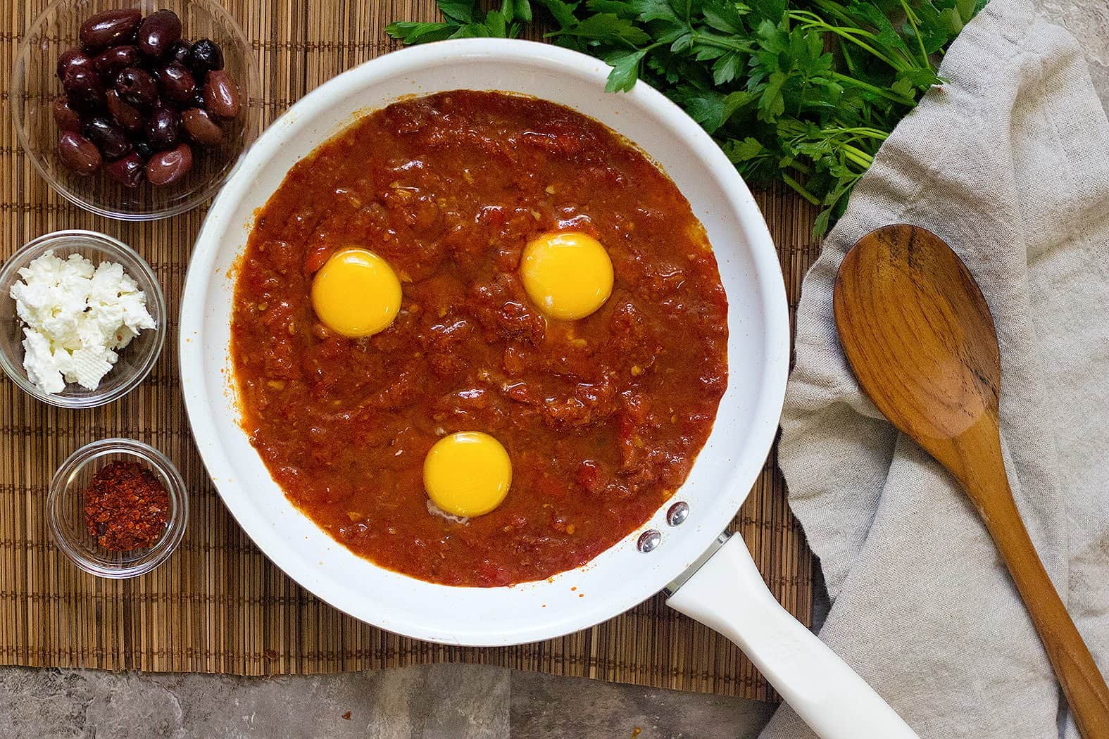 Next add in eggs and cook until eggs are poached and shakshuka is ready.