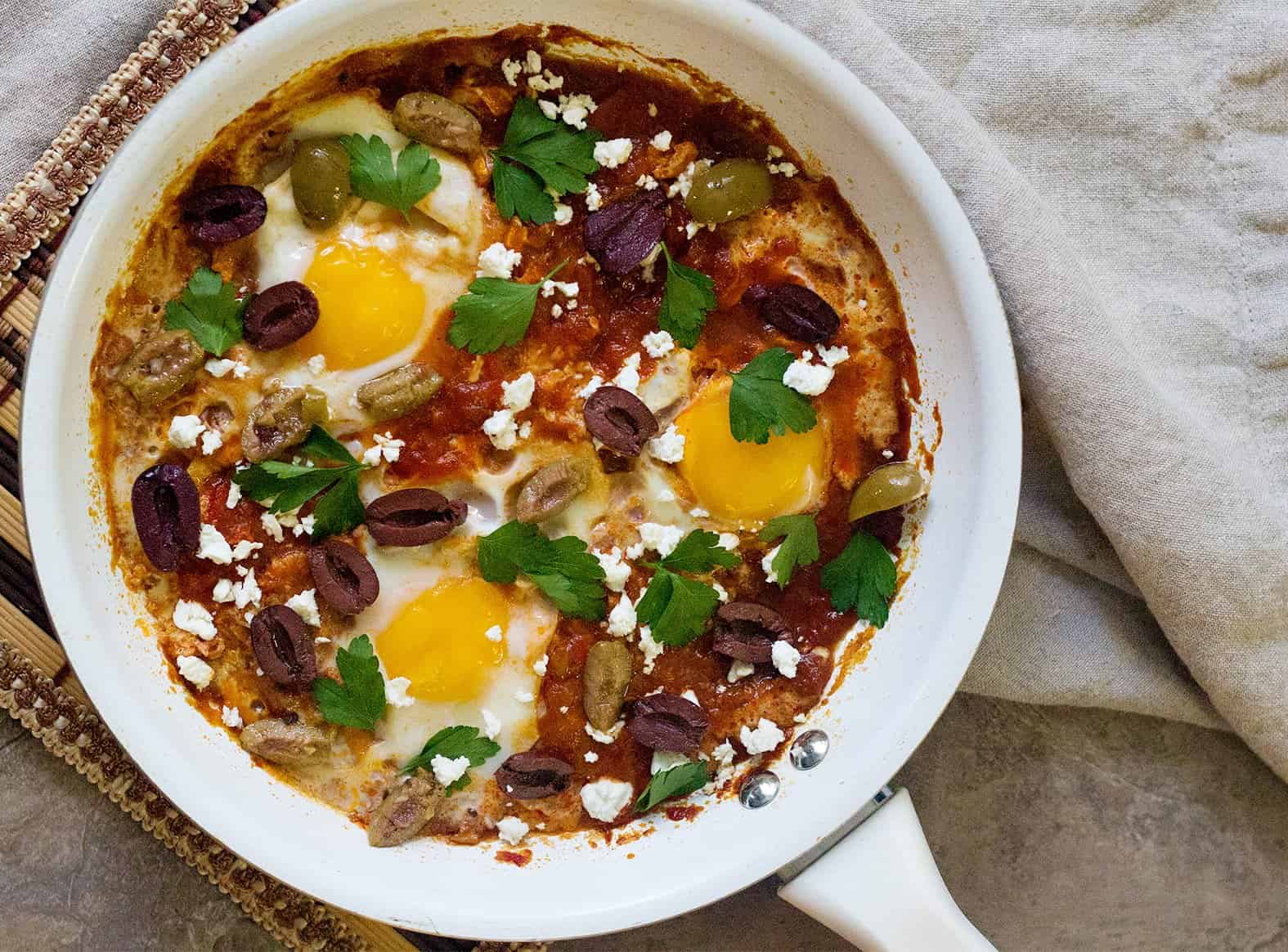 Top shakshuka with feta and olives and serve. 