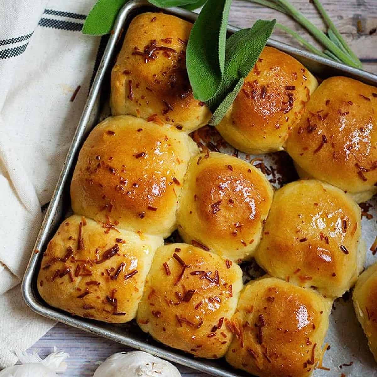 These Sage Parmesan Garlic Buns are the best buns you will ever make. Fluffy and buttery rolls topped with garlic and sage are too good to pass on!
