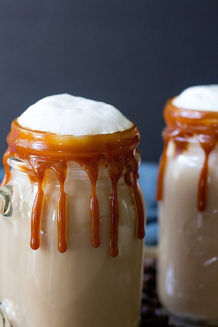 Homemade caramel latte topped with foamed milk. 