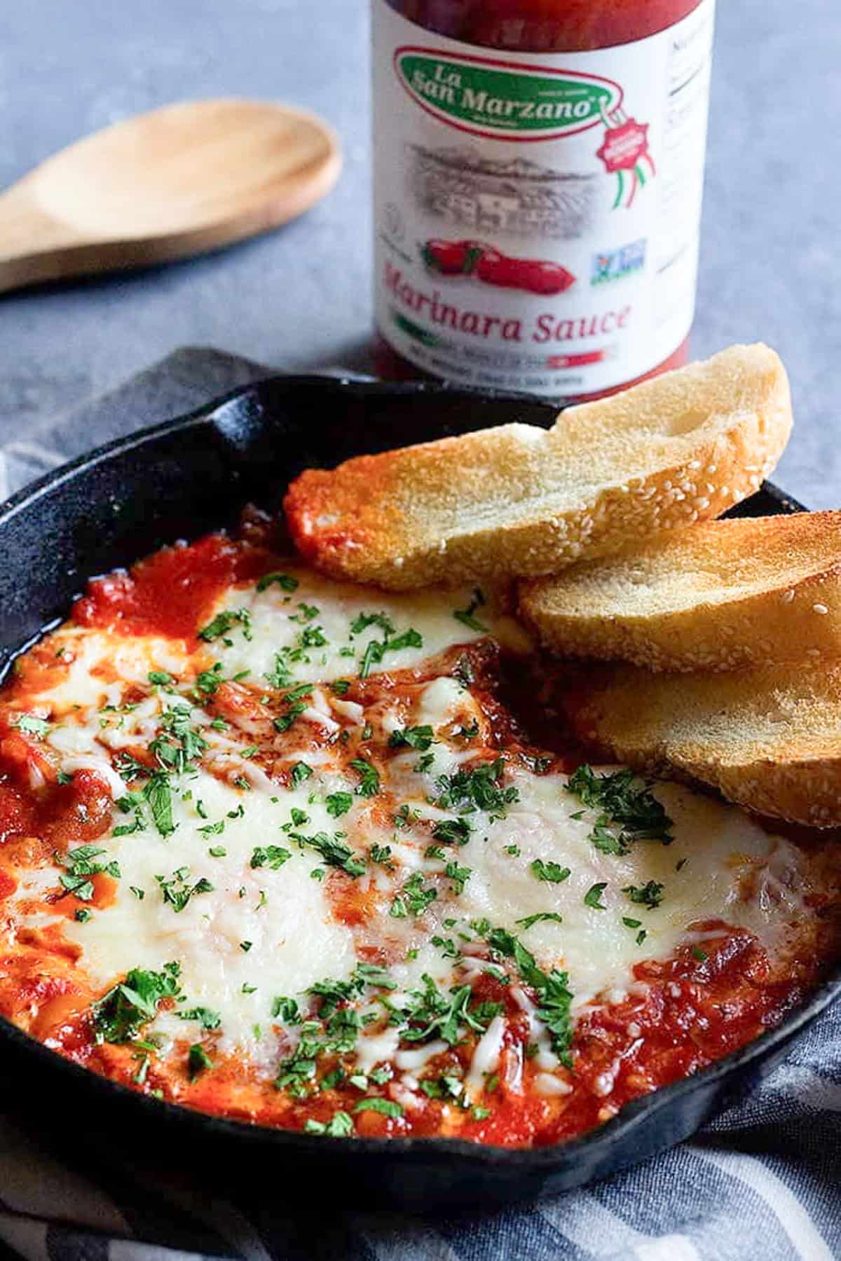 Top breakfast egg bake with chopped parsley.