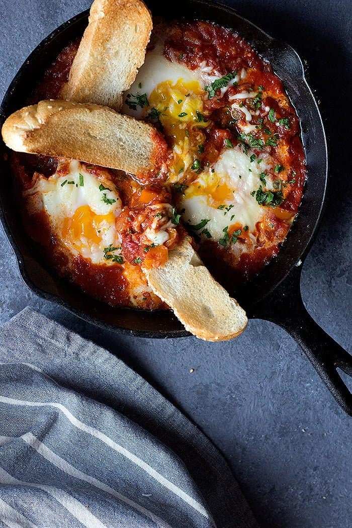Serve Italian baked eggs with crispy bread. 
