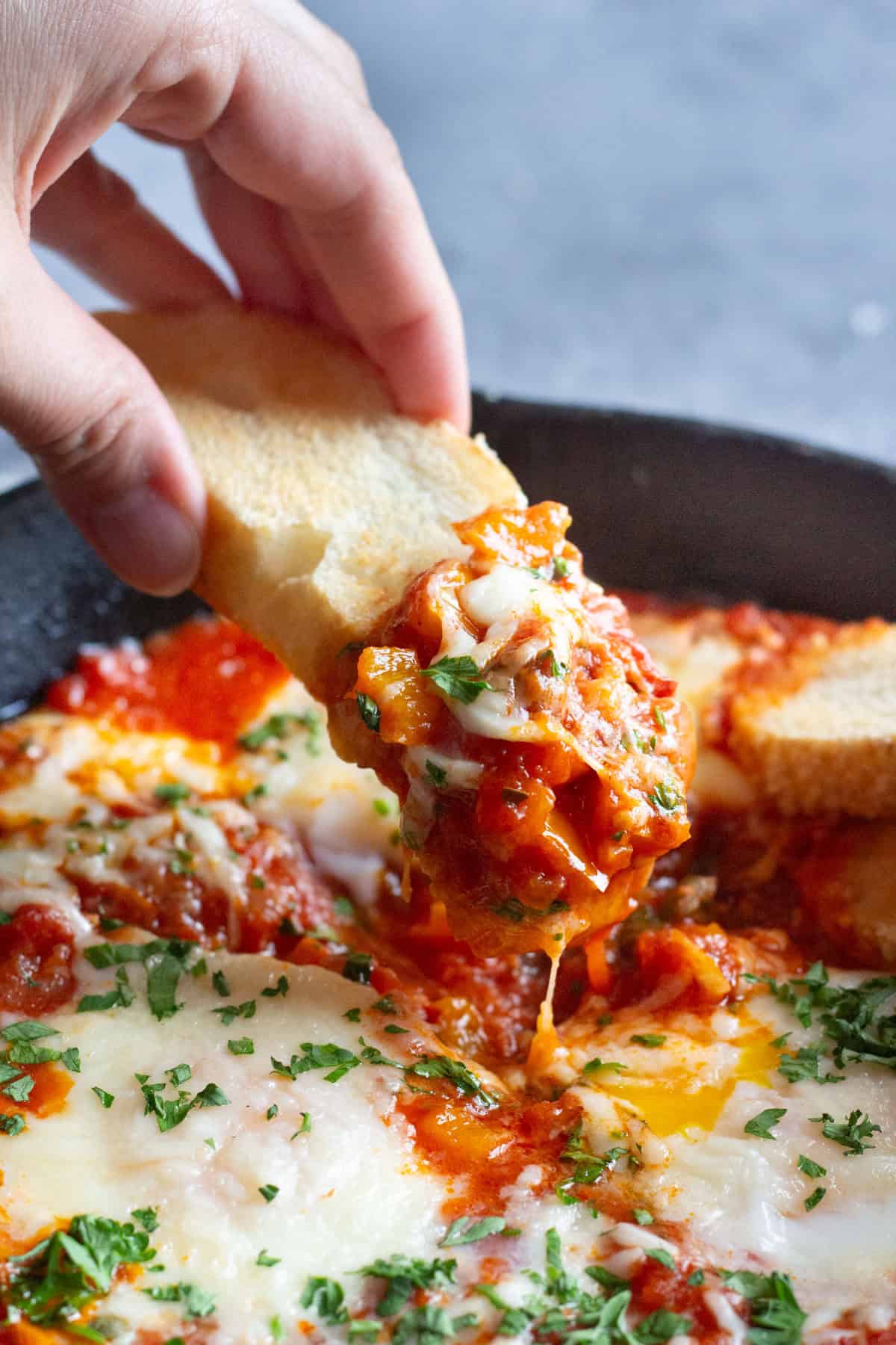 Dip the bread into cheesy delicious baked eggs.