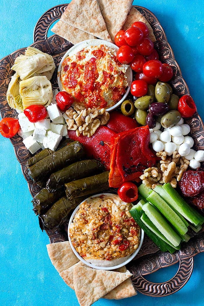 Mezze platter is great for entertaining. You can make it with hummus, dolma, olives and feta cheese.