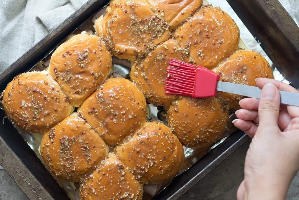 Brush the top of the sliders with melted butter and mustard. 