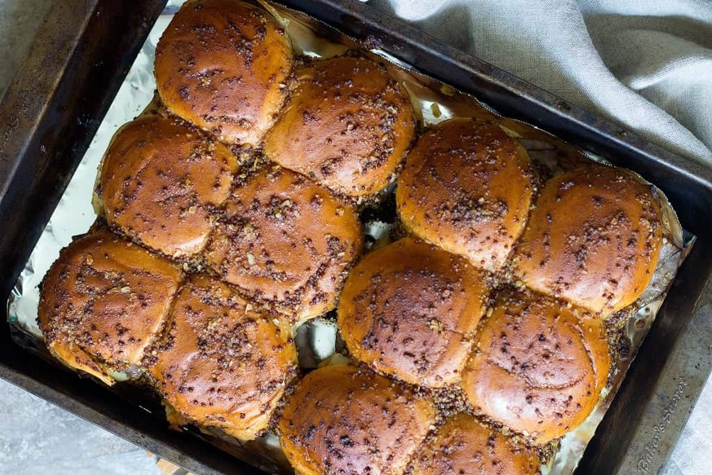 Cooked sliders with golden top and melted cheese. 