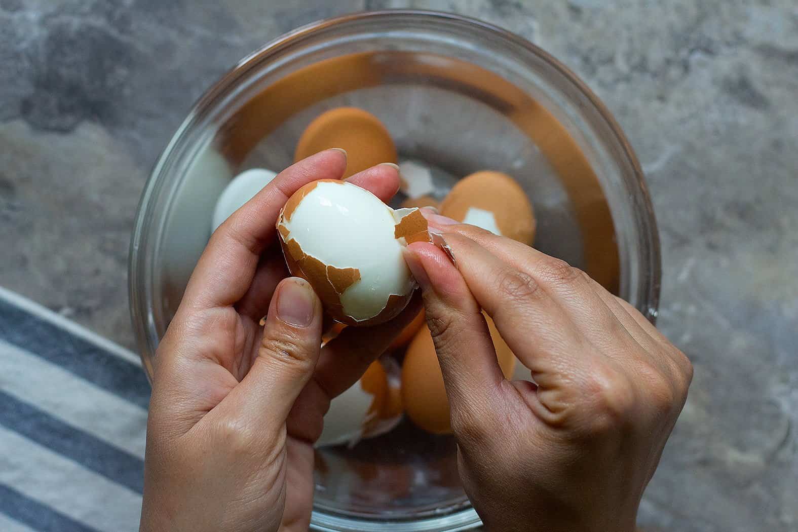 Instant pot hard boiled eggs are the easiest eggs to peel. After they cool in the water bath, roll each egg on the counter to crack and then start peeling right away.