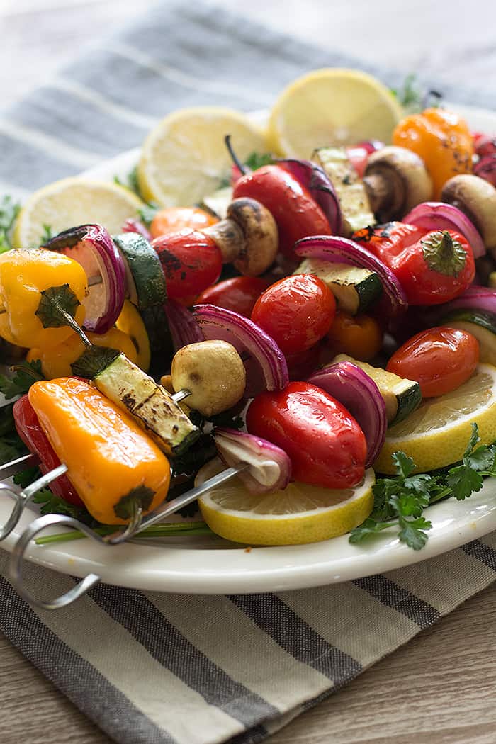 vegetable kabob is made with peppers, zucchini, tomatoes, mushrooms and onion. 