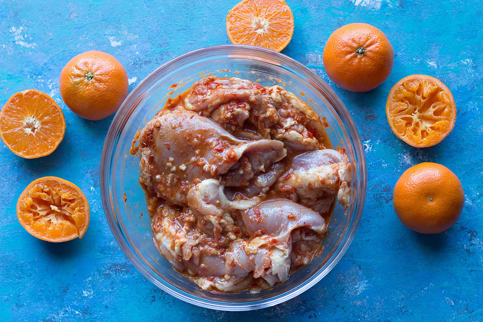 Mix chicken thighs, harissa, clementine juice and garlic in a large bowl.