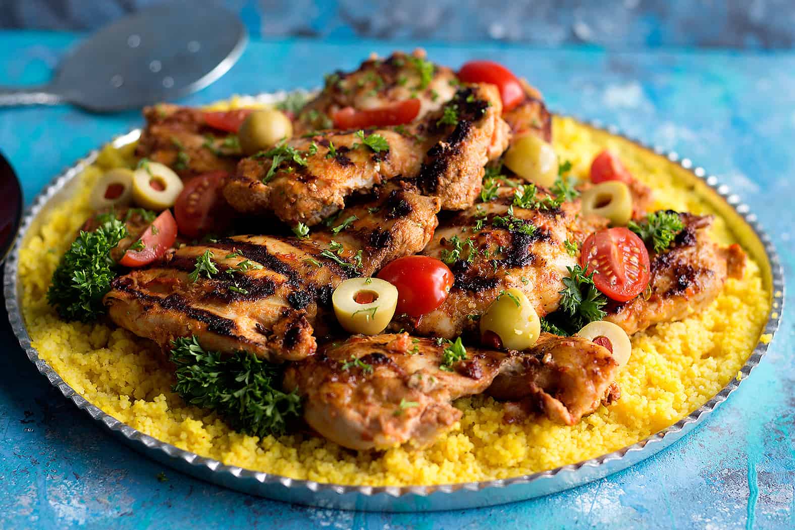 Serve Moroccan harissa chicken with saffron couscous