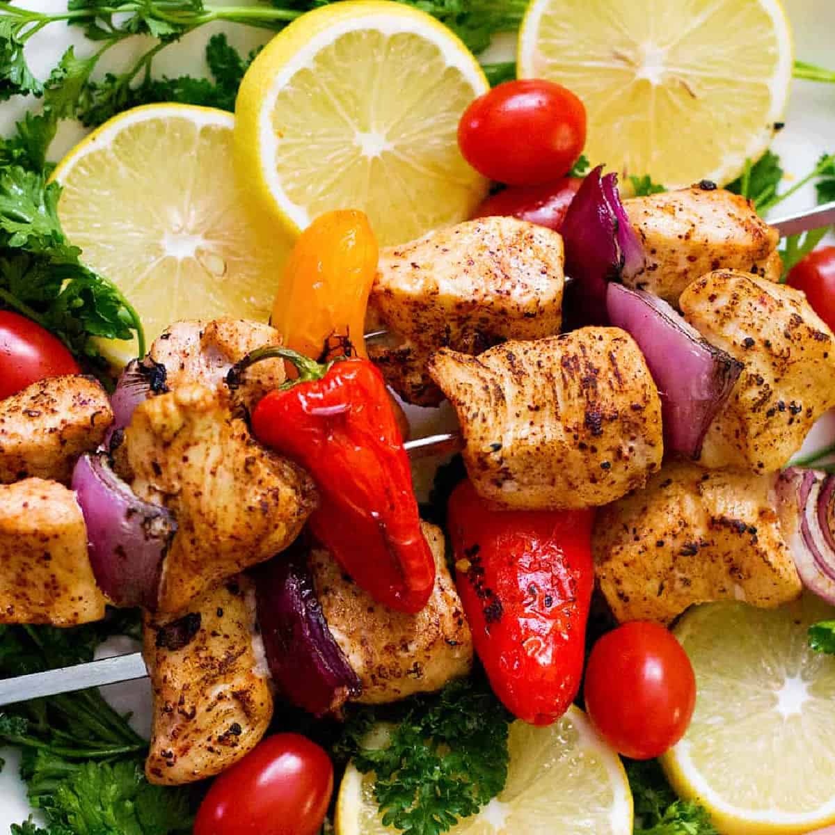 Chicken shish kabob on a platter. 