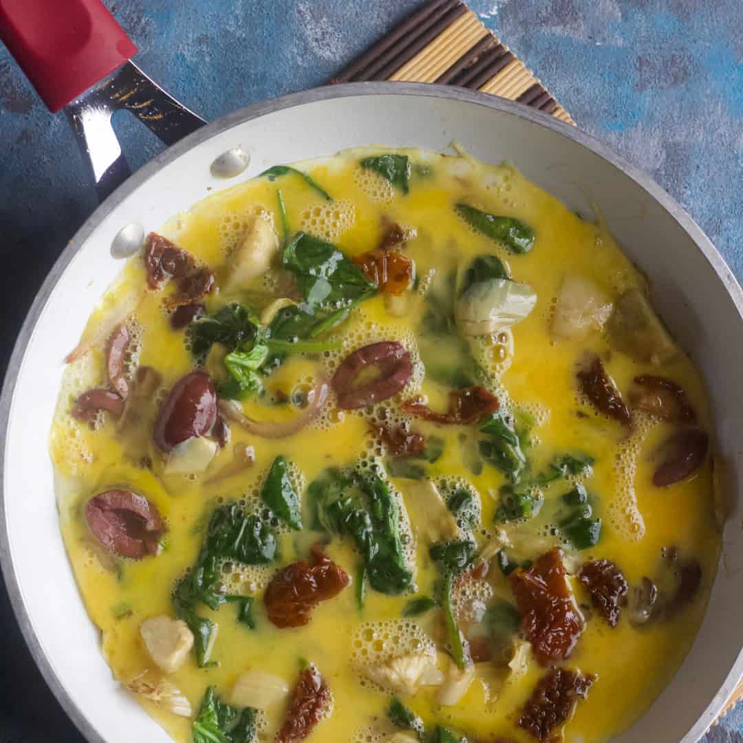 Crack the eggs in a bowl and lightly whisk them. Add them to the sauteed vegetables. Season with salt and pepper. Cover and cook until the eggs are set.