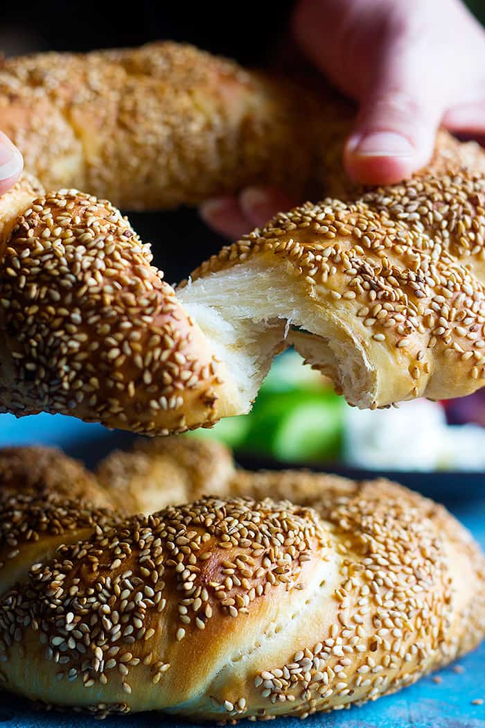 Turkish simit is a delicious sesame crusted bread that you can have for breakfast. Learn how to make traditional simit recipe at home with this step-by-step tutorial. 