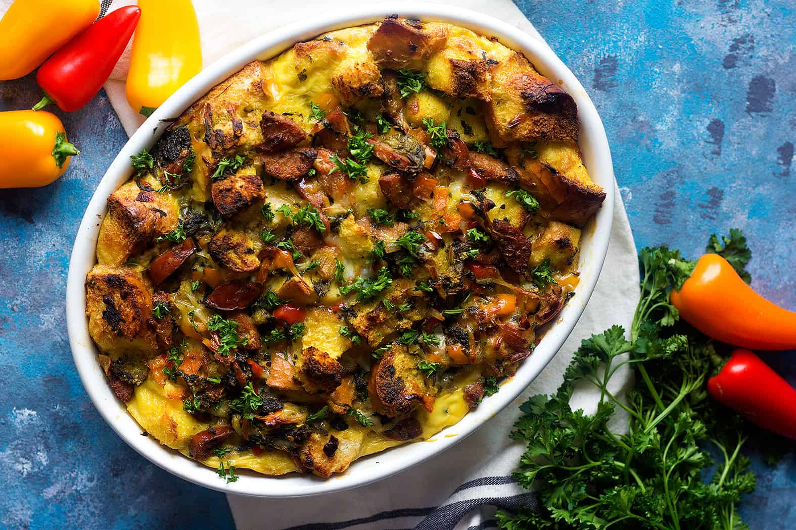 Savory bread pudding is great for brunch. This sausage bread pudding with spinach and asparagus is full of delicious ingredients and very easy to prepare.