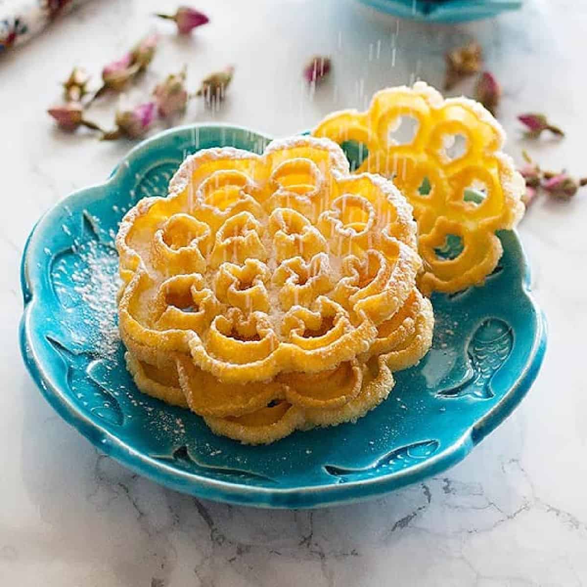 Nan Panjereh - Persian Rosettes is a traditional Persian cookie that is crisp and light. Once you find the technique, it is easy and fun to make!
