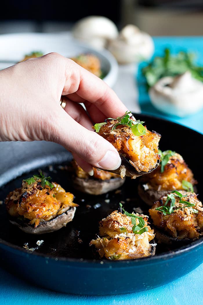 Cooked crab stuffed mushrooms topped with parsley and scallions