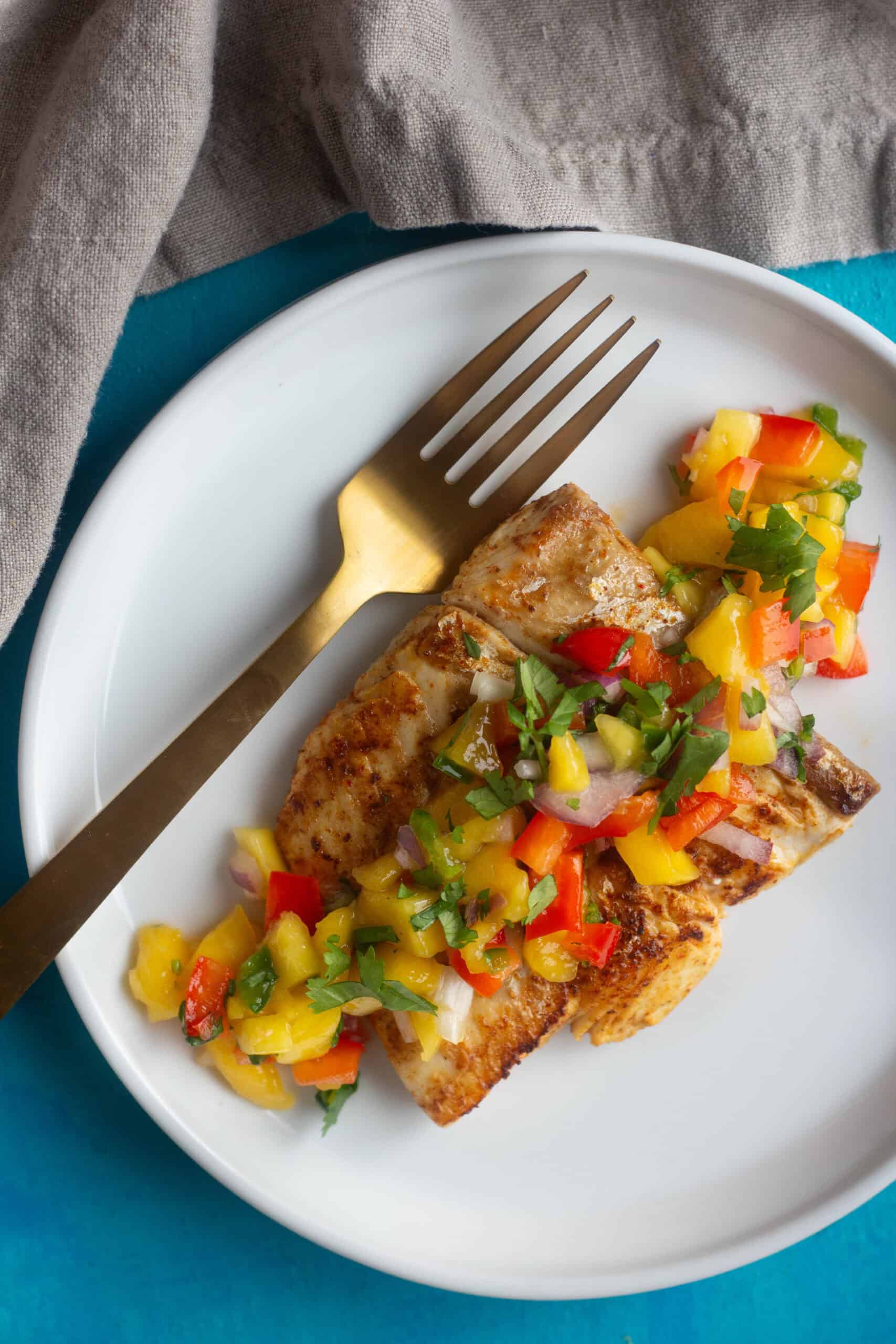 Learn how to grill Alaska halibut perfectly at home. Serve grilled halibut with spicy mango salsa for a celebration of flavors. 
