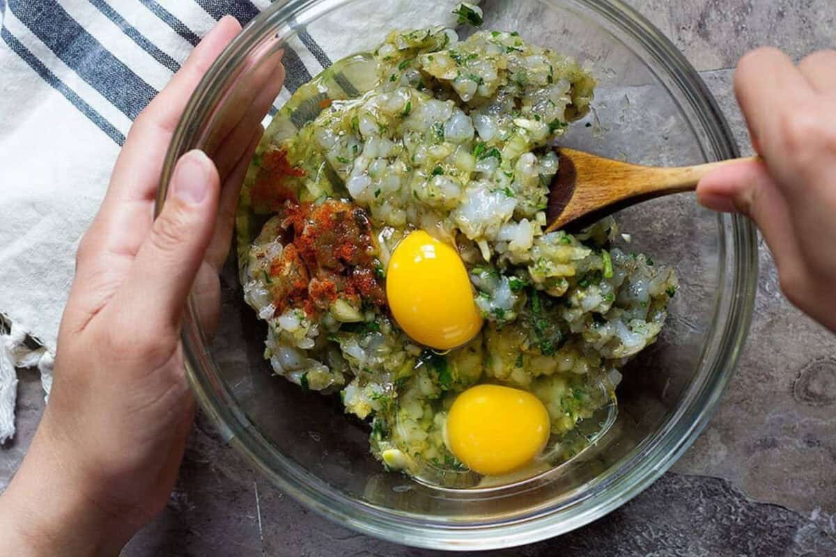 For this shrimp cake recipe mix all the ingredients in a large bowl and make small patties.