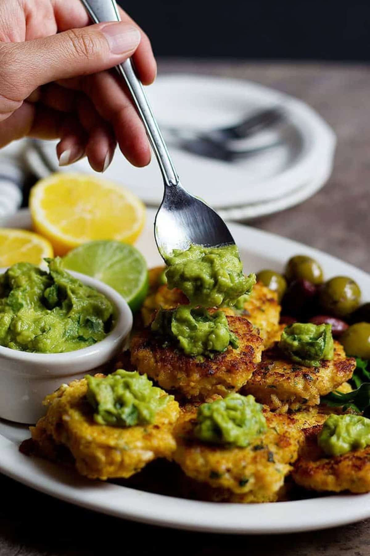 Top shrimp cakes with zesty avocado sauce. 