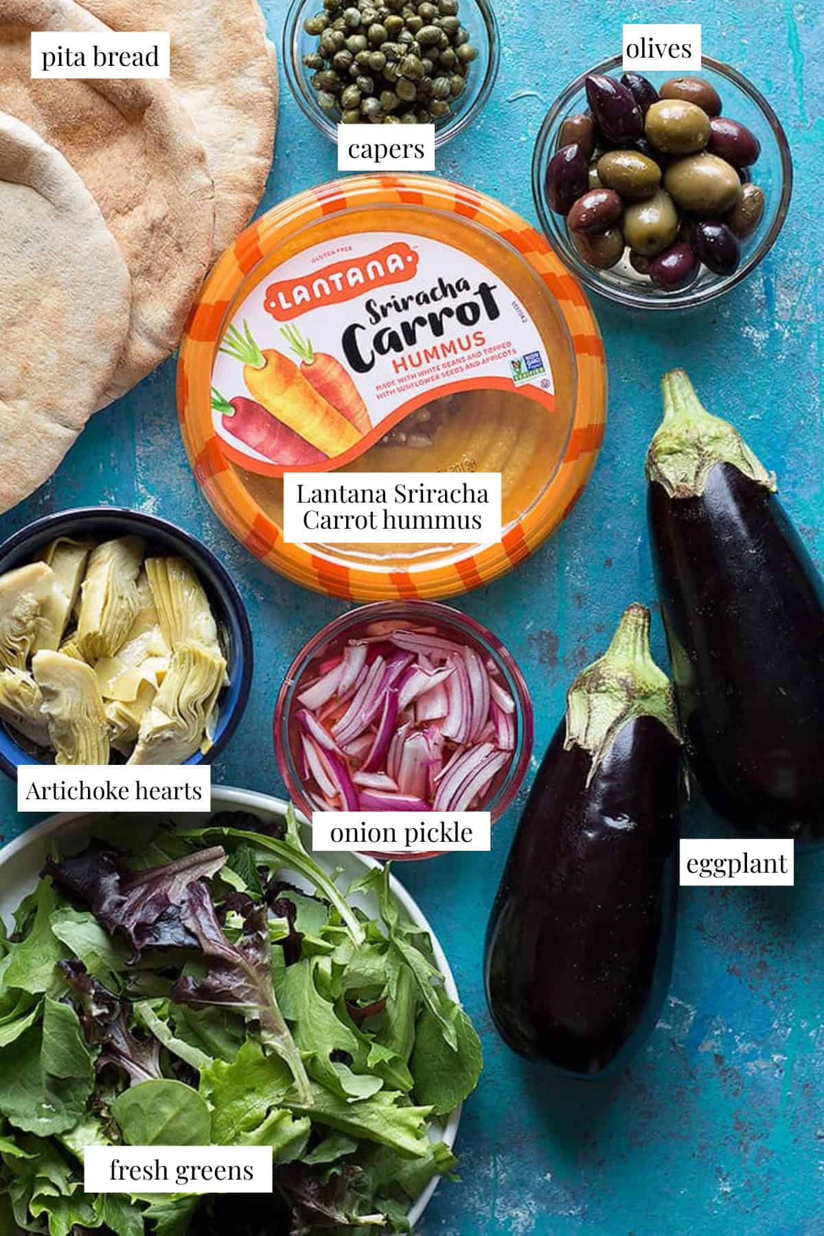 to make grilled eggplant sandwich you need pita bread, eggplants, hummus, olives, greens, artichokes, capers and onions. 