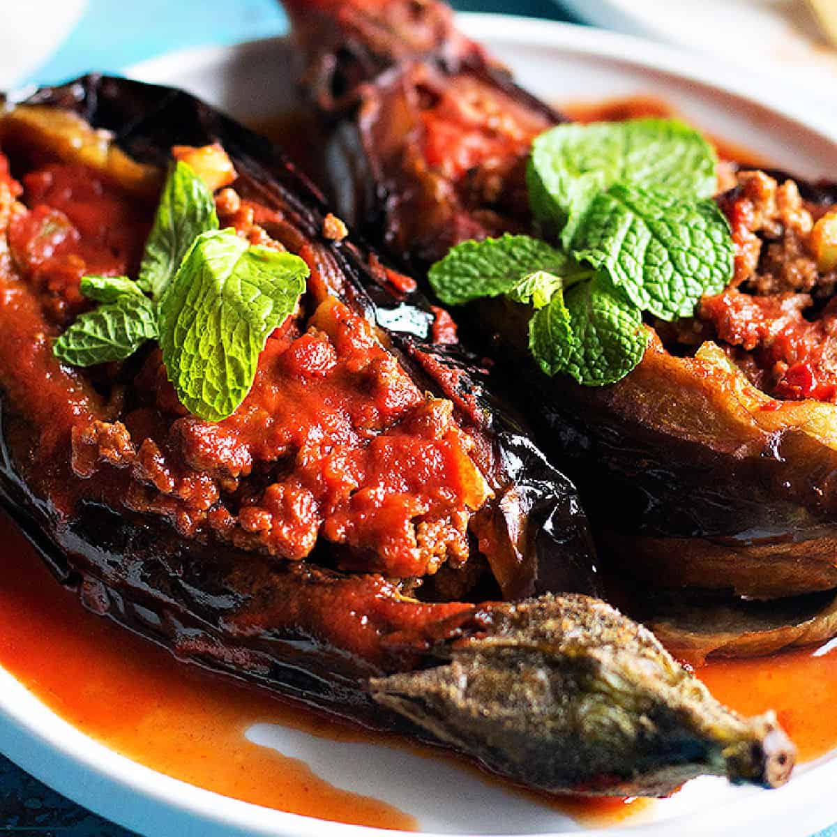 Karniyarik is a classic Turkish stuffed eggplant recipe. Delicious eggplants are stuffed with a tasty ground beef, pepper and tomatoes filling and are baked to perfection. 
