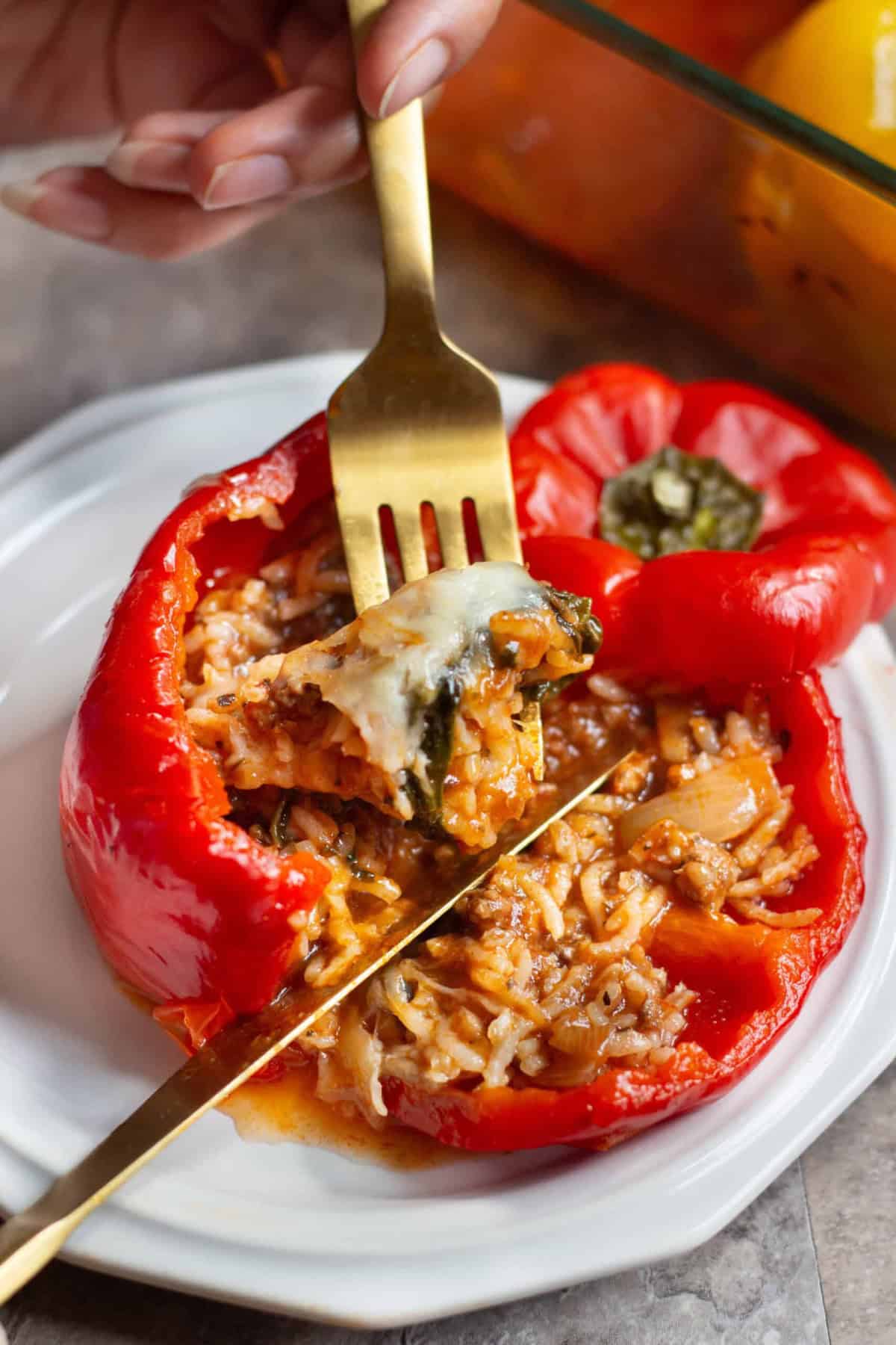 Italian Stuffed Peppers Recipe Italian stuffed pepper o a plate and sliced.
