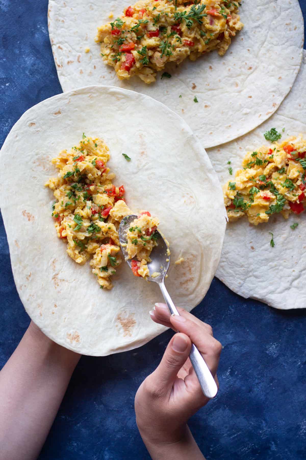 pour eggs into onion and peppers. 