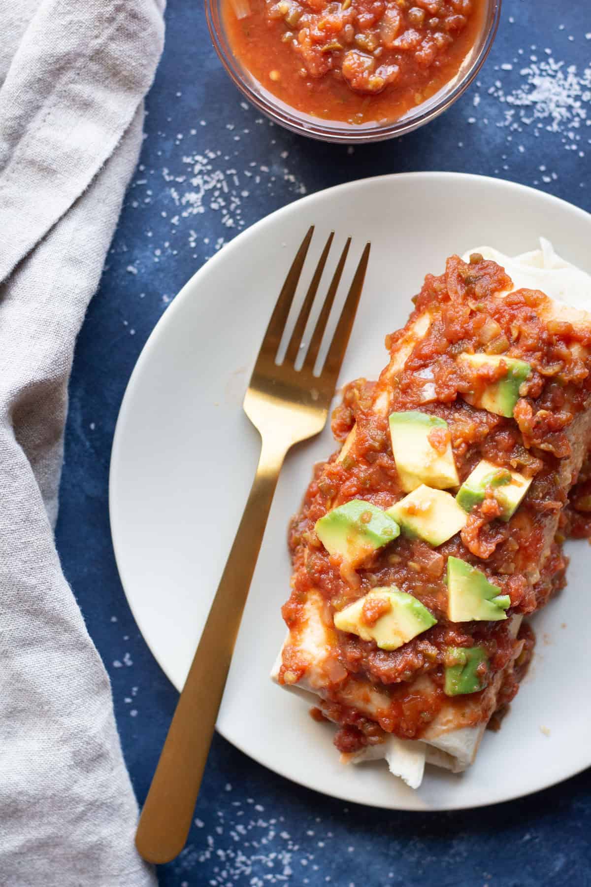 top the vegetarian breakfast burrito with warm salsa and avocados and serve. 