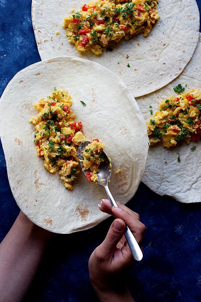 fill the tortillas with eggs and veggies and roll them