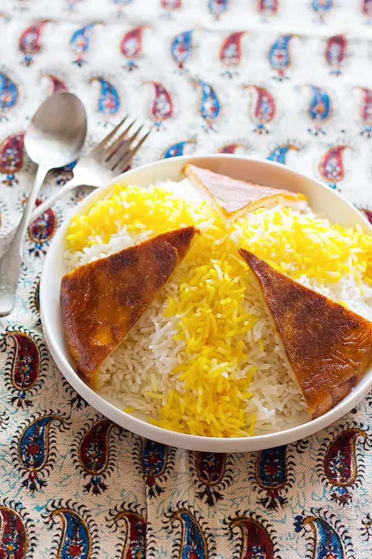 Persian Rice and Tahdig. Infuse some of the rice with brewed saffron and spread over the white Basmati Rice.