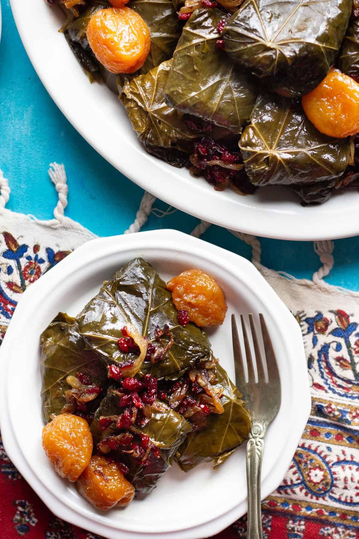 stuffed grape leaves made Persian style served on three plates.