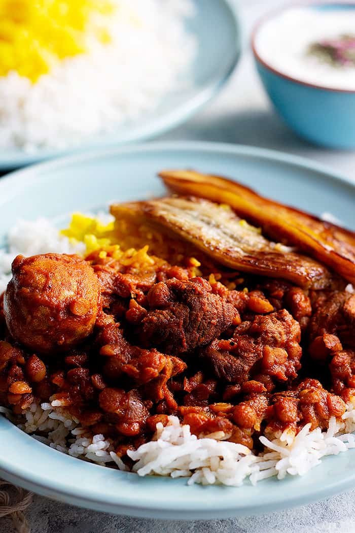 a plate of rice with split chickpea stew. 