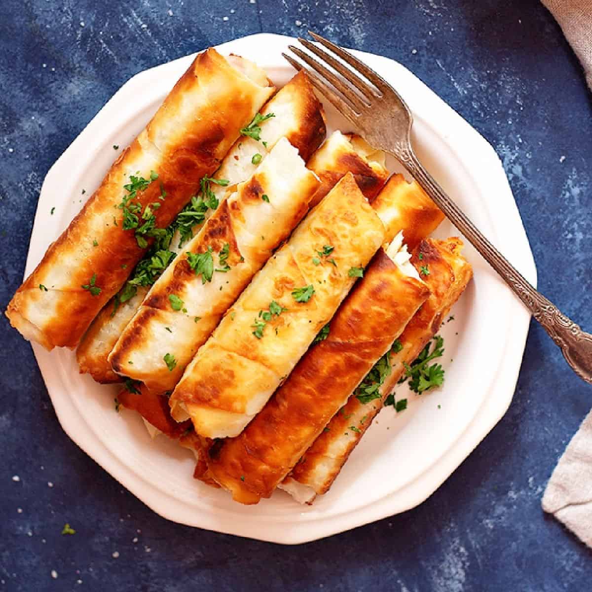 Borek is a Turkish savory crunchy pastry filled with different fillings such as cheese or potatoes. Learn how to make Turkish borek recipe by watching our step-by-step video and tutorial. They are perfect as a midday snack or for breakfast and you can make them in advance and freeze them for later. 
